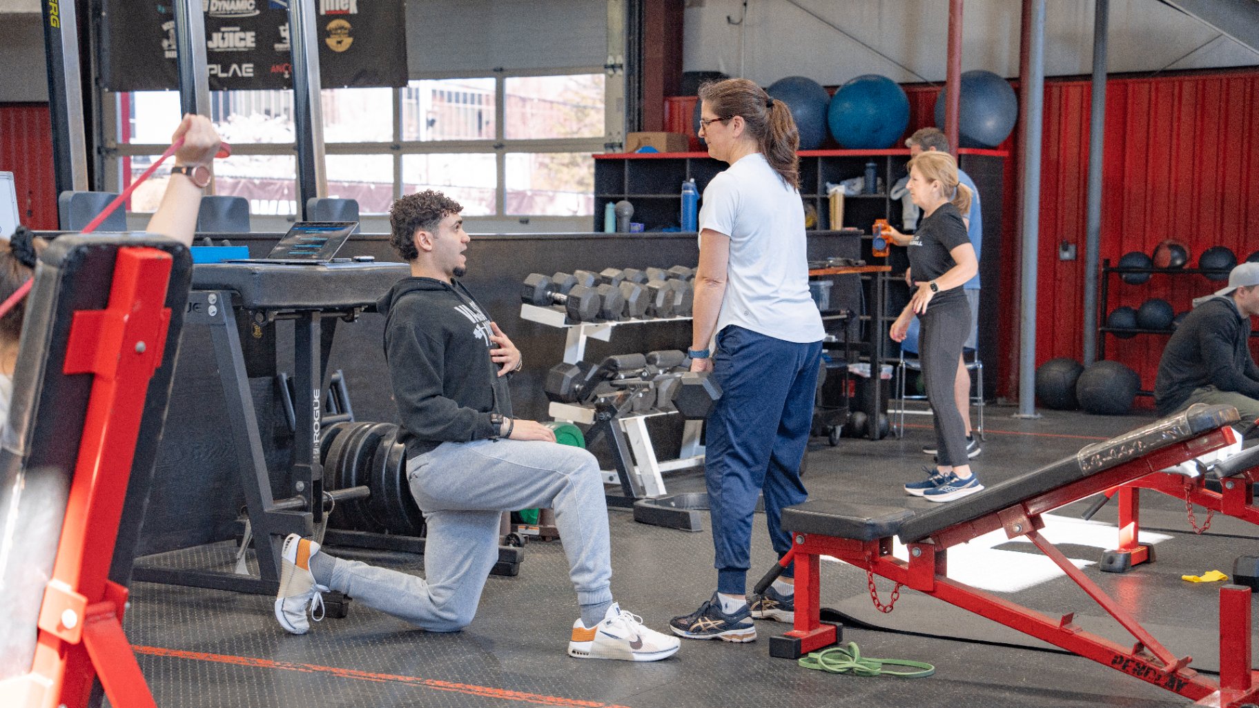 A Varsity House coach working one-on-one with a member during a small-group training session