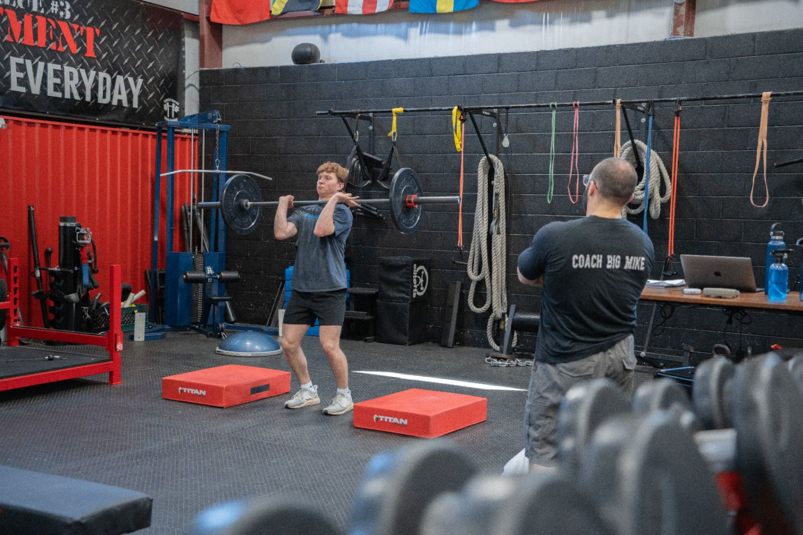 Young athletes and adults training together across the Varsity House floor