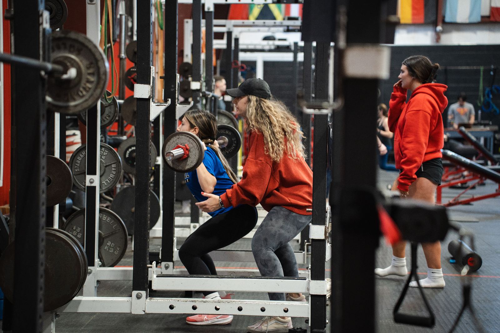 Youth athletes doing resisted sprint work on the turf during performance training